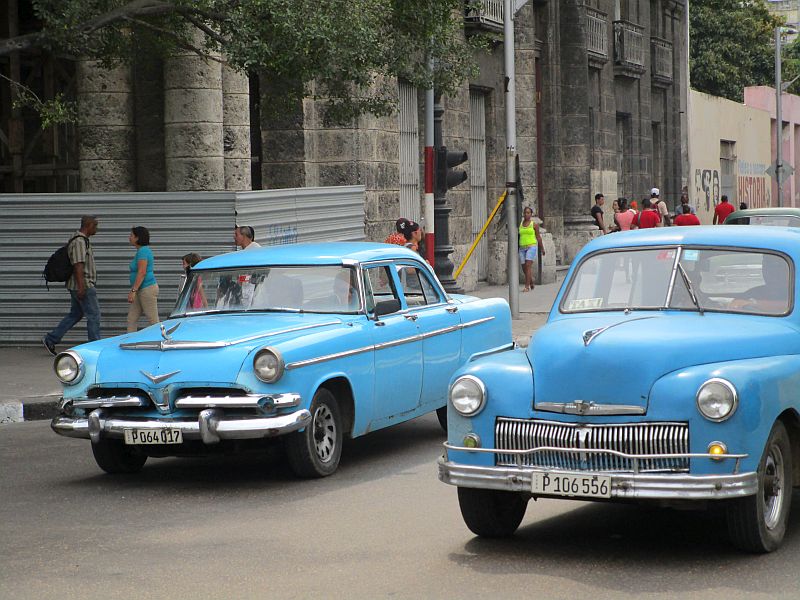 Two Antique Taxis on the Streets of Havana